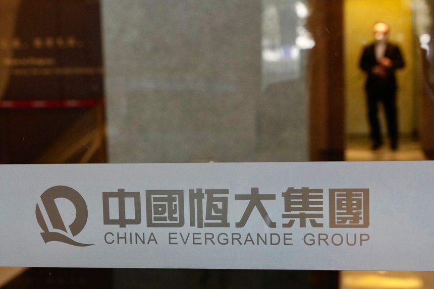 A glass door with a sign that reads 'China Evergrande Group' in English and Chinese.